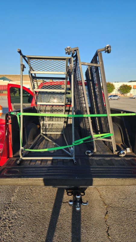 Loading a pair of free rolling ladders onto the trailer